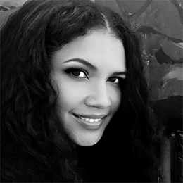 A black-and-white portrait photo of Michelle Amthor in three-quarter profile. She is smiling at the camera with a focused gaze.
